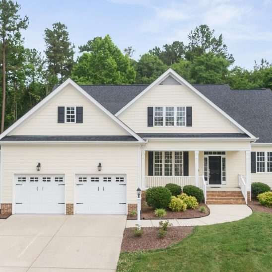 A beautiful suburban house with a green lawn and spacious driveway in Wendell, NC.